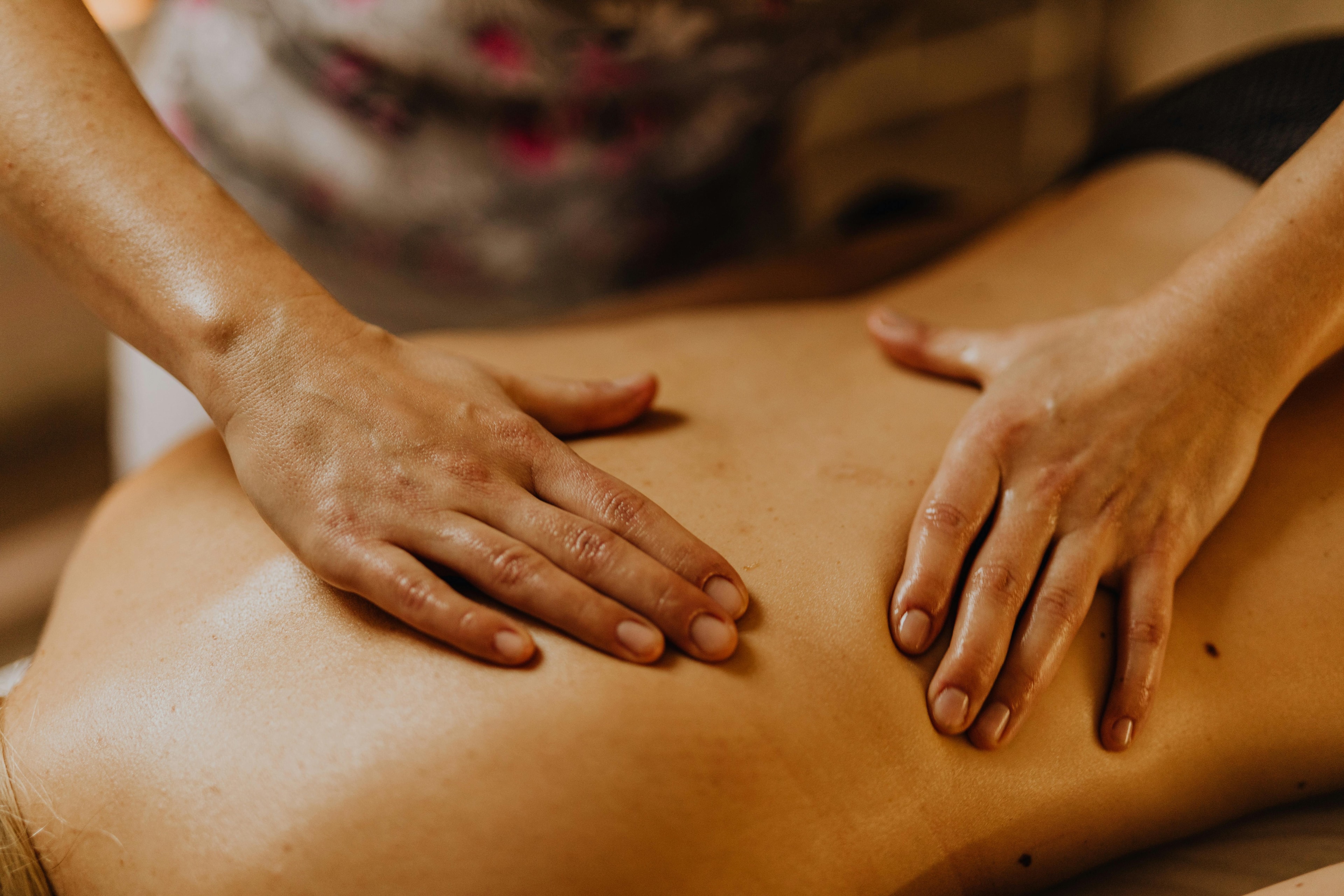 Hands performing a back massage